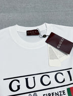 Gucci white T-shirt laid flat with neckline tag and partial logo print