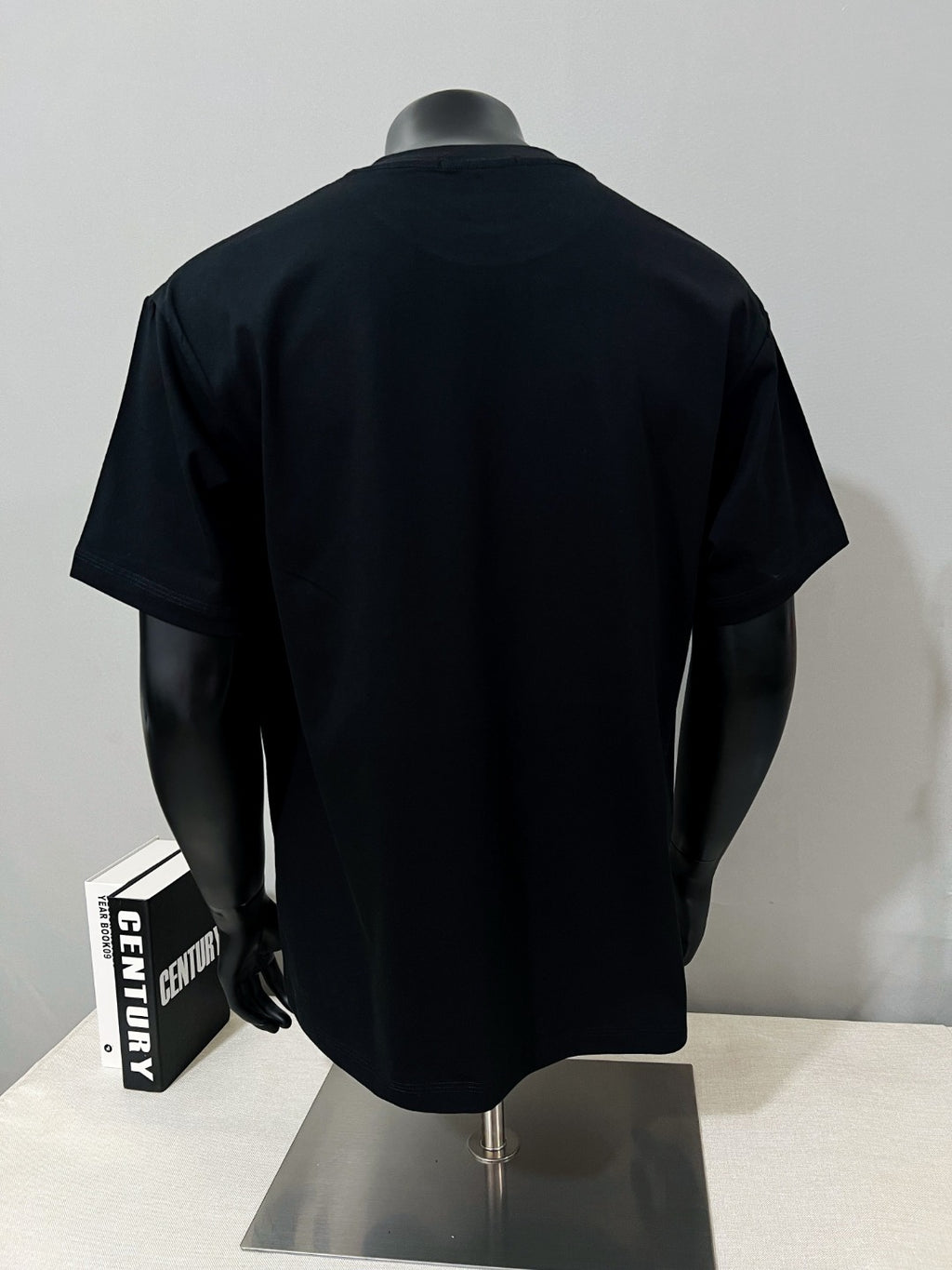Black T-shirt back view on mannequin