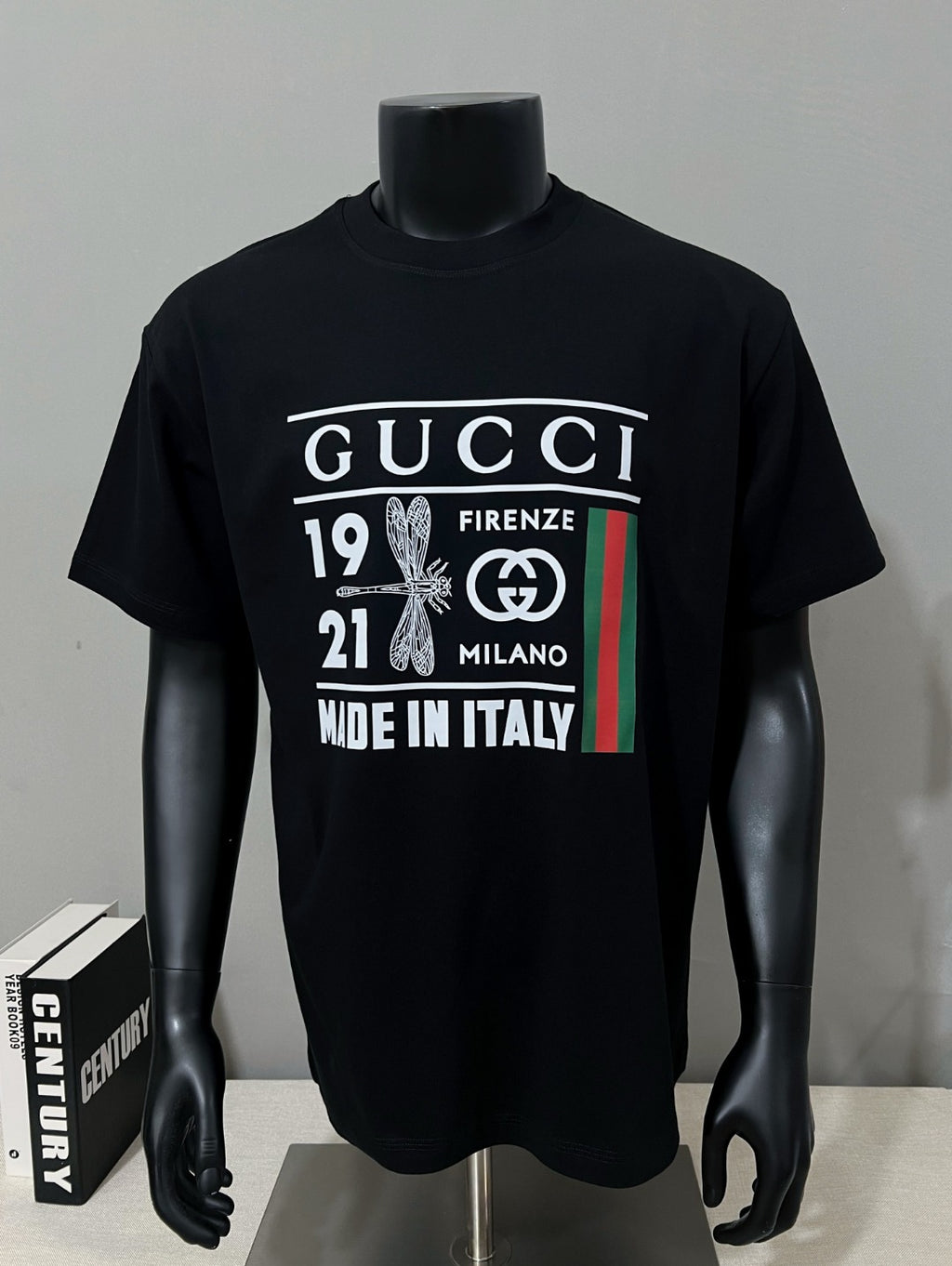 Black graphic T-shirt on mannequin with Gucci Firenze Milano print