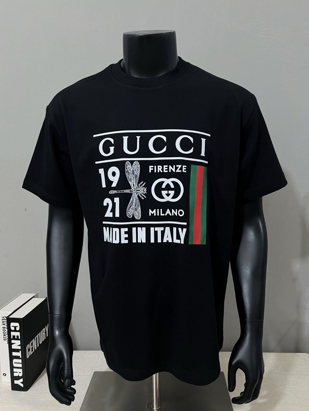 Black graphic T-shirt on mannequin with Gucci Firenze Milano print
