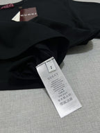 Black T-shirt care label tag with size and wash instructions