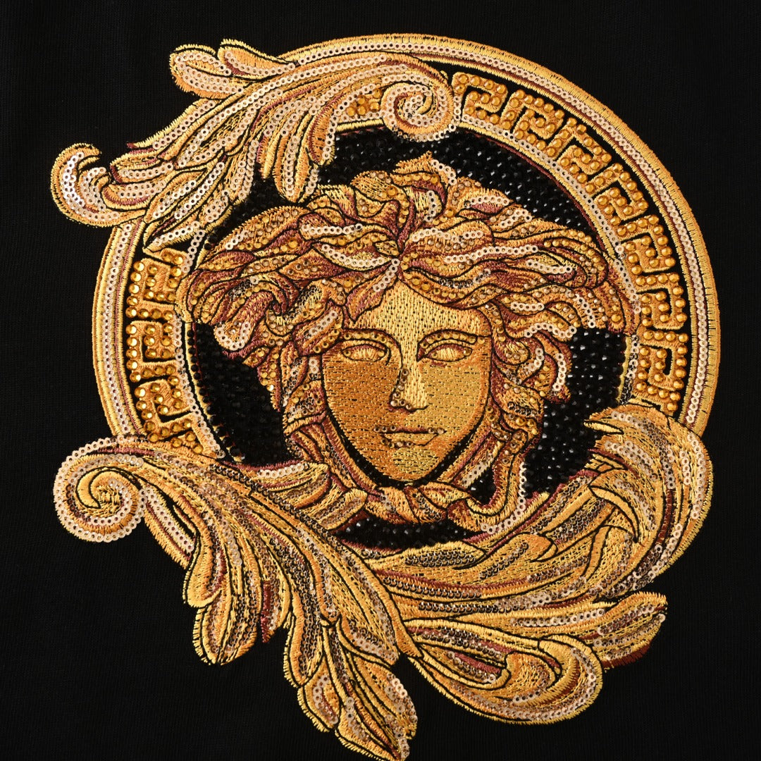 Gold Medusa crest graphic with ornate circular border on a black Versace T-shirt