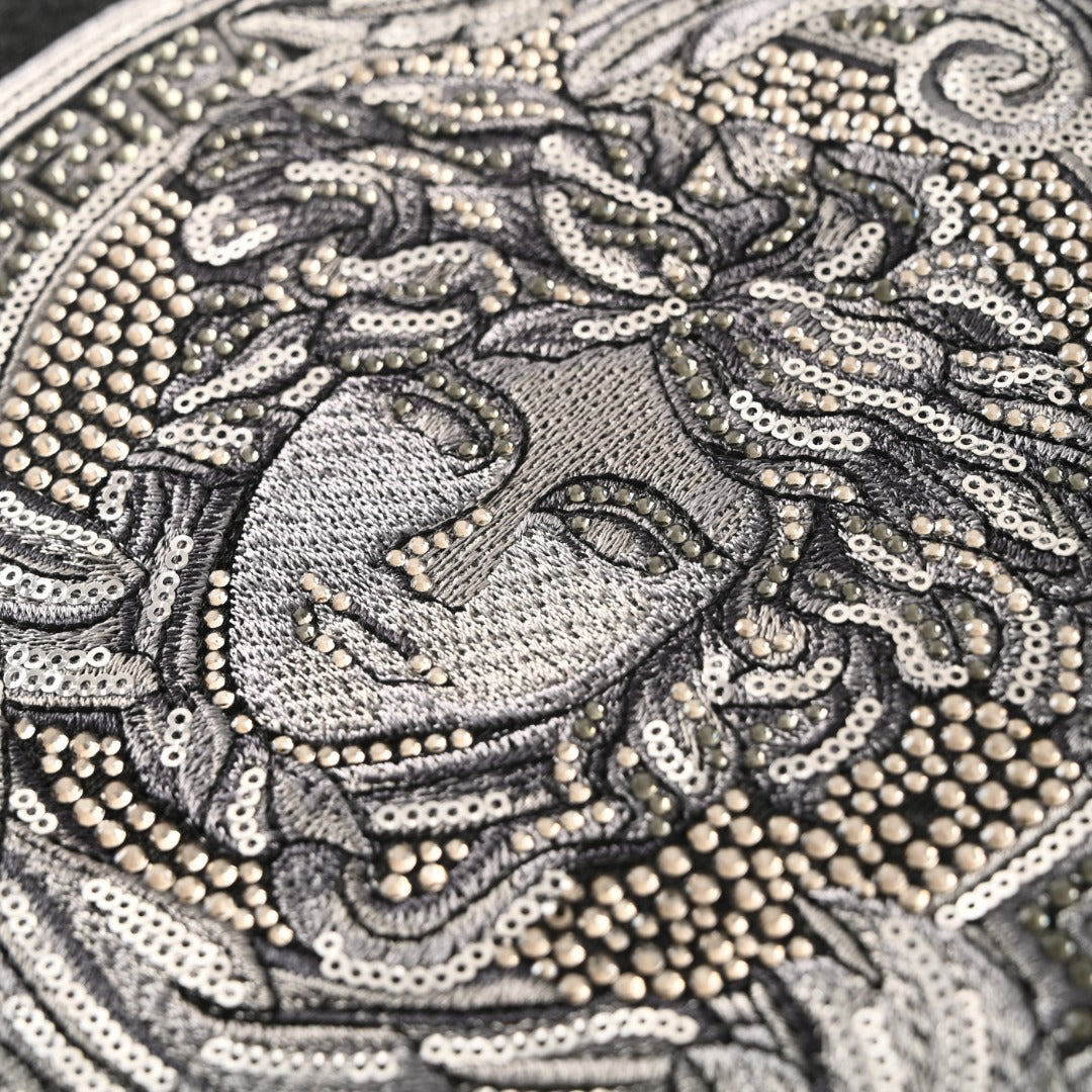 Versace T-shirt close-up of the sequined Medusa face graphic in silver tone