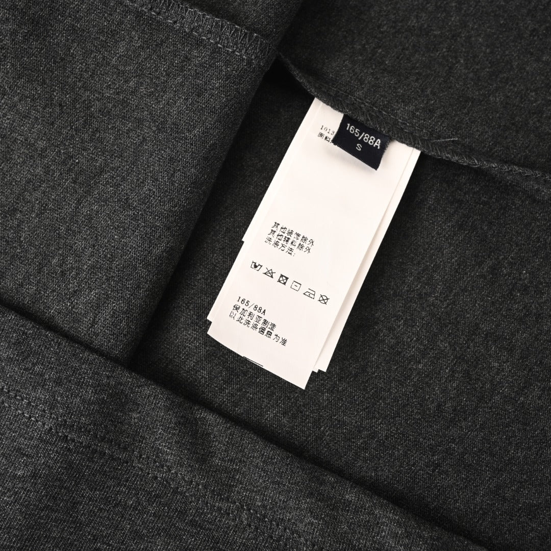 Versace T-shirt inside size label on dark gray fabric