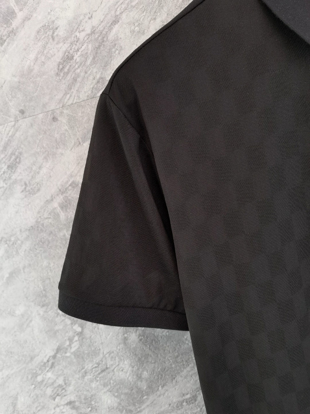 Louis Vuitton black short-sleeve polo shirt sleeve and side seam detail