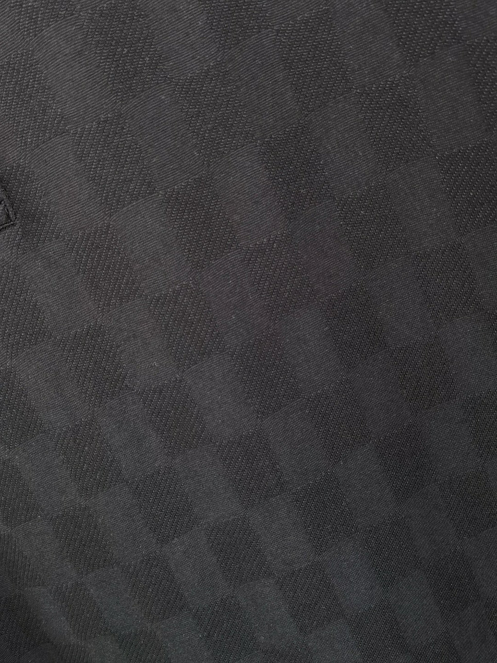 Black polo shirt fabric texture close-up