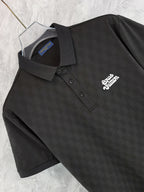 Black polo shirt front with button placket and chest logo