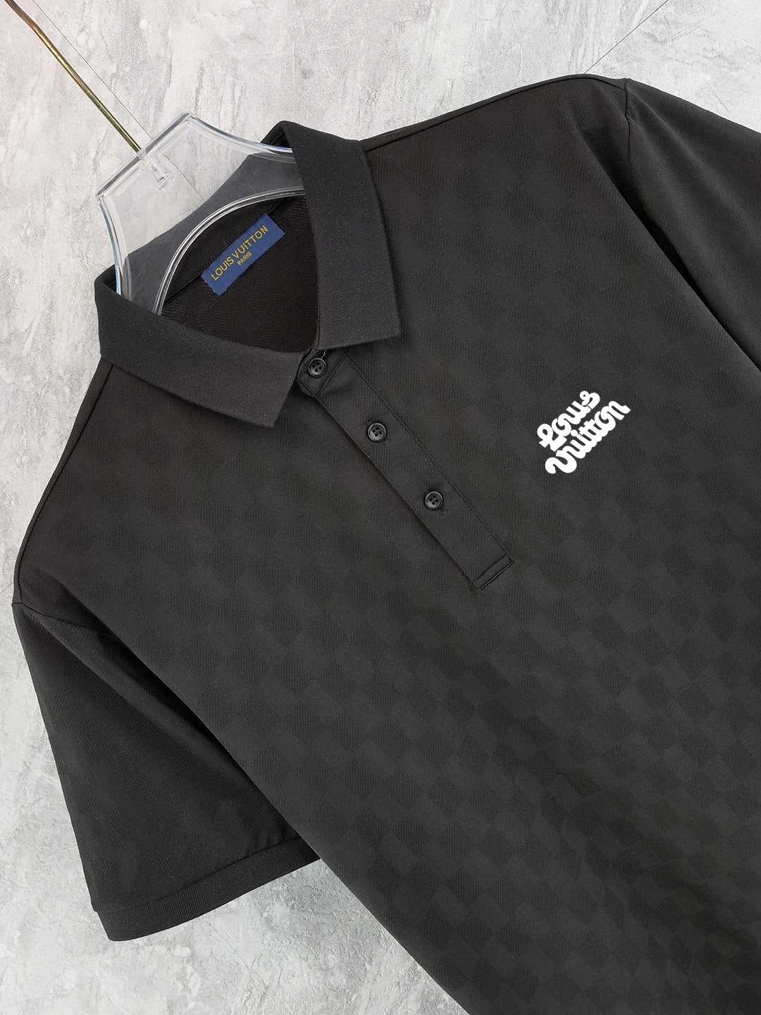 Black polo shirt front with button placket and chest logo