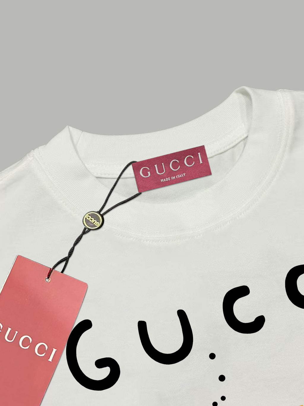 White Gucci T-shirt neckline with Gucci label and hang tag