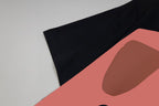 Black Gucci T-shirt sleeve and face graphic print with pink shape.