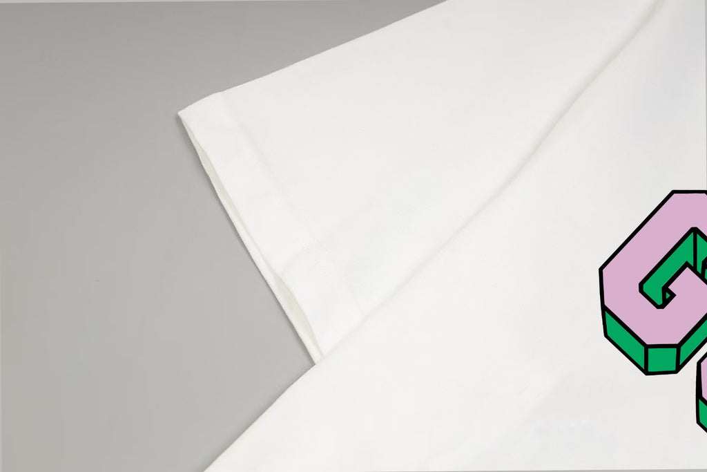 White T-shirt sleeve and side seam detail with colorful GUCCI logo edge
