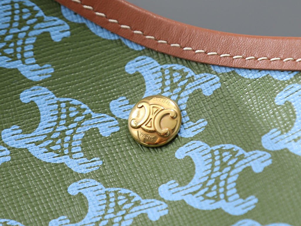 Celine logo snap clasp on green fabric with blue patterned detail