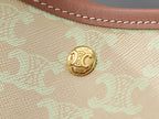 Celine gold logo button on light beige textured bag fabric