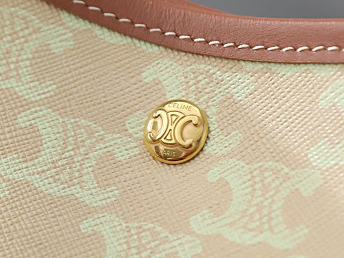 Celine gold logo button on light beige textured bag fabric