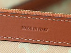 Brown leather trim with stitched edge and “MADE IN ITALY” embossing