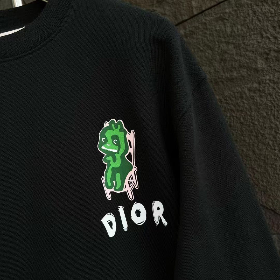 Black crewneck sweatshirt side view with green character graphic and DIOR logo.