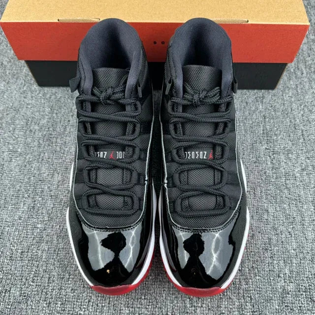 Black, red, and white high-top sneakers with lace-up design and patent toe panels