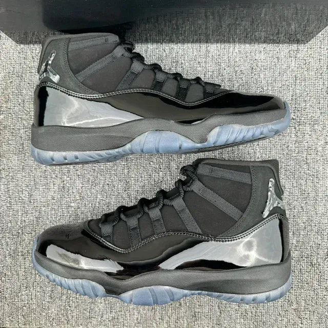Pair of Jordan 11 high-top sneakers, dark gray and black uppers with gray soles