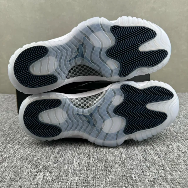 Jordan 11 sneaker bottom view, translucent tread with navy zigzag pattern
