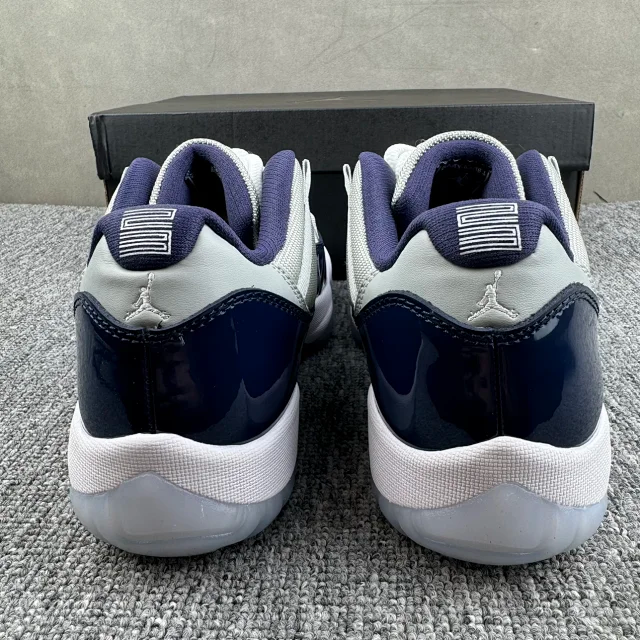 Jordan 11 sneakers heel view, cream collar and navy glossy side panels