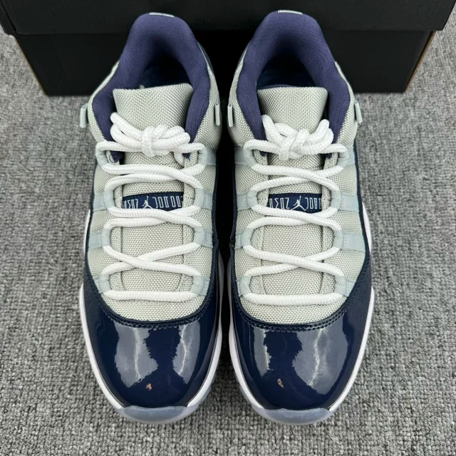 Jordan 11 sneakers front view, cream mesh and navy glossy toe caps