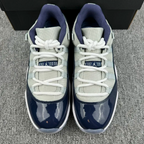 Jordan 11 sneakers front view, cream mesh and navy glossy toe caps