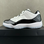 White and black low-top sneakers with white laces and glossy black side panels
