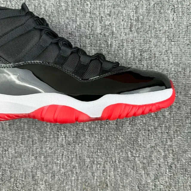 Black high-top sneaker side view with lace-up closure and red-and-white midsole