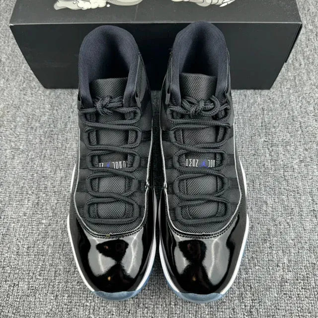 Black, white, and blue high-top sneakers with laces and patterned toe panels.