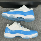 White and blue low-top sneakers with mesh-style panel and patterned outsole