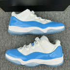 Pair of white and blue low-top sneakers on a grey surface