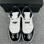 White and black low-top sneakers with white laces and padded tongue detail
