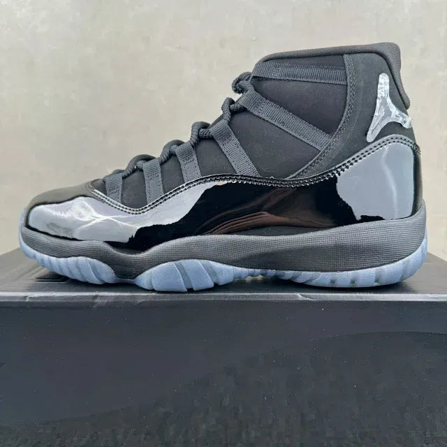 Jordan 11 high-top sneakers with dark gray upper and silver side panel, lace-up front