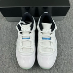 Pair of white sneakers with black heel lining and lace-up closure