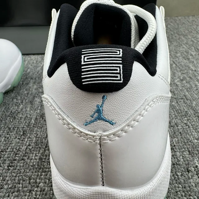 Close-up of white sneaker heel with black patch and blue Jumpman logo