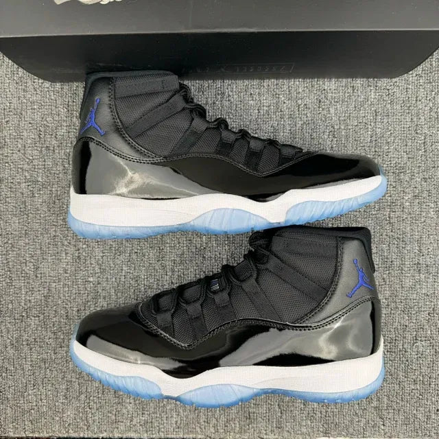 Pair of black high-top sneakers with white midsole and blue outsole, side by side.