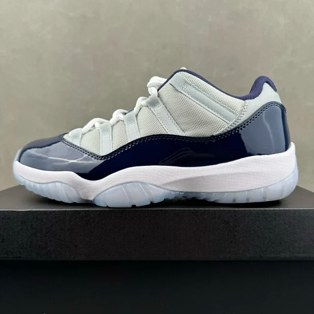 Low-top Jordan 11 sneakers, cream and navy, white laces and outsole