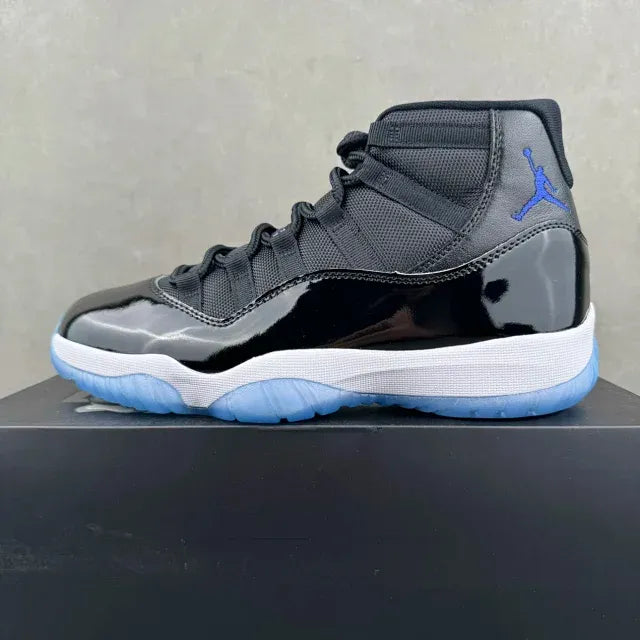 Single black high-top sneaker on box with blue Jumpman logo and white midsole.