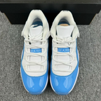 Back view of white and blue low-top sneakers with heel tabs and laces