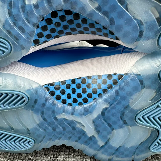 Close-up of blue translucent outsole with tread and speckled traction pattern