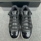 Jordan 11 lace-up sneakers with black-and-gray uppers and speckled graphic detail