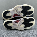 Jordan 11 outsoles with black zigzag tread and red accent, cream rubber