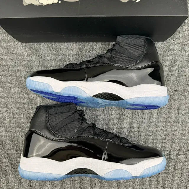 Black high-top sneakers open view with white lining and blue rubber outsole.