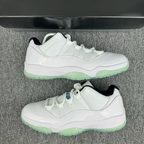 White low-top sneakers with green outsole and blue side accent detail