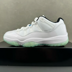 White low-top sneakers with green outsole and blue accent detail at side