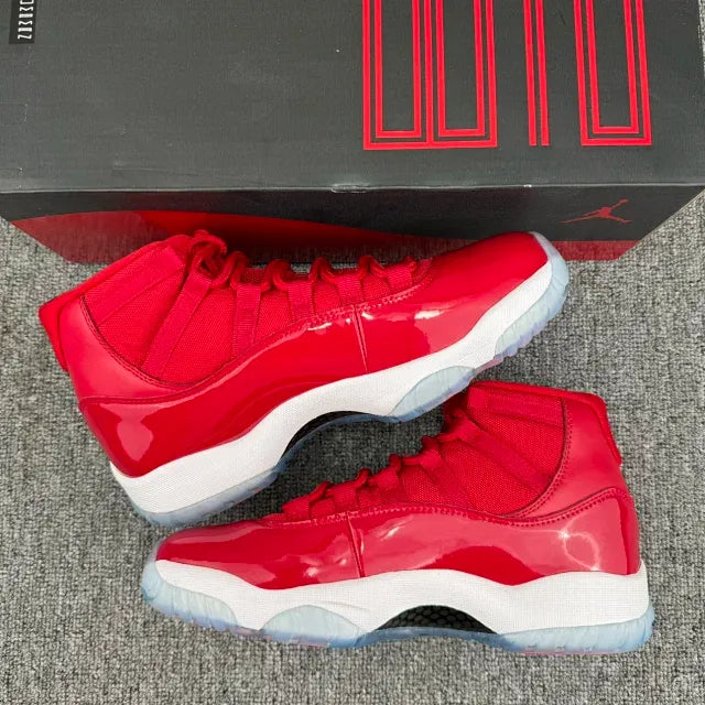 Pair of red high-top sneakers on a box, with white midsole and blue outsole