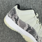 Low-top sneaker showing side quarter with gray-and-black snakeskin print and white leather panel