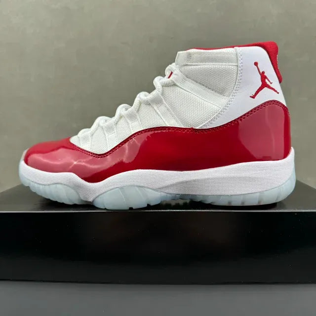 Red and white high-top sneakers with white laces and red patent side panels
