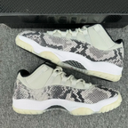 Pair of low-top snakeskin sneakers with white uppers, black-gray pattern, and off-white soles