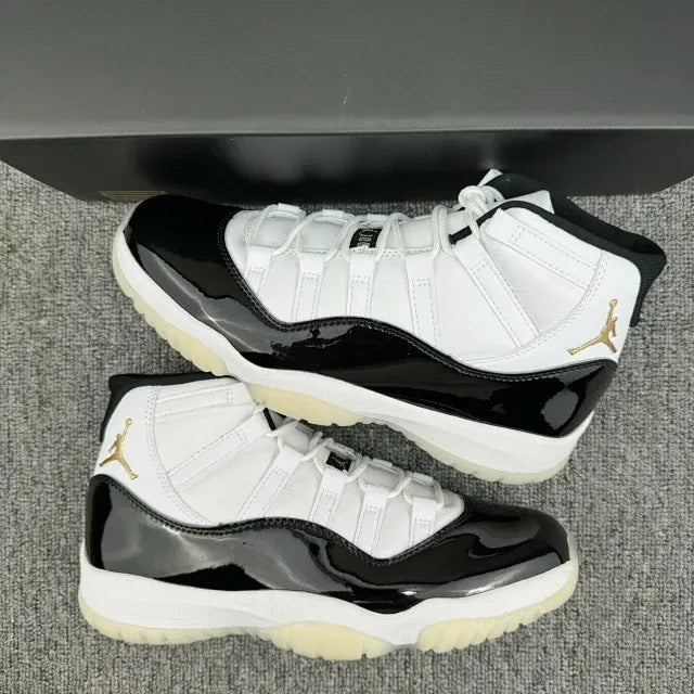 Pair of white and black Jordan 11 sneakers with patent black paneling